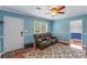 Comfortable living room with hardwood floors, a ceiling fan, and a cozy leather couch at 1770 Rockland Se Dr, Atlanta, GA 30316