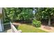 A lovely backyard with stone firepit, mature trees and a partial view of deck at 2123 Condor Dr, Lawrenceville, GA 30044