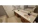 A spacious bathroom featuring double sinks, white countertops, and dark wood cabinets at 2123 Condor Dr, Lawrenceville, GA 30044