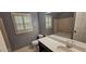 Bathroom featuring a single vanity, toilet, and tub/shower combo with natural light at 2123 Condor Dr, Lawrenceville, GA 30044
