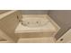 A luxurious white bathtub with jets and tile surround, perfect for relaxation at 2123 Condor Dr, Lawrenceville, GA 30044