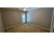 A cozy bedroom with a door leading to the outside, neutral walls, and plush carpet at 2123 Condor Dr, Lawrenceville, GA 30044