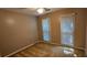 A cozy bedroom with natural light from two windows, neutral paint, and plush carpet at 2123 Condor Dr, Lawrenceville, GA 30044