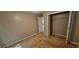 A bright bedroom featuring a closet and a door, with neutral walls and plush carpet at 2123 Condor Dr, Lawrenceville, GA 30044