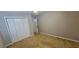 A bright bedroom featuring a closet and a door, with neutral walls and plush carpet at 2123 Condor Dr, Lawrenceville, GA 30044