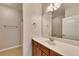 A bathroom boasts a large mirror and vanity with wooden cabinets and drawers at 2384 Tree Arbor Way, Marietta, GA 30064