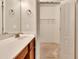 Bathroom features a vanity with a white countertop and cabinet storage, with a peek into a closet at 2384 Tree Arbor Way, Marietta, GA 30064