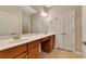 Bathroom with double sink vanity, stylish faucets, and ample storage in the cabinets and linen closet at 2384 Tree Arbor Way, Marietta, GA 30064