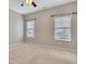 Well-lit bedroom with neutral walls, carpet flooring and two windows at 2384 Tree Arbor Way, Marietta, GA 30064