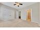Inviting bedroom with neutral tones, carpet, ceiling fan and views of the ensuite bathroom at 2384 Tree Arbor Way, Marietta, GA 30064