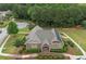 This aerial shot shows the clubhouse featuring a cozy deck, professional landscaping, and an American flag at 2384 Tree Arbor Way, Marietta, GA 30064