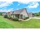 Beautiful home exterior showcasing a lush lawn and landscaping, plus covered porch with a ceiling fan at 2384 Tree Arbor Way, Marietta, GA 30064