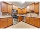 Well-equipped kitchen with stainless steel appliances, tile backsplash, and wooden cabinetry at 2384 Tree Arbor Way, Marietta, GA 30064