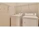 Utility room features washer and dryer units with wire shelving at 2384 Tree Arbor Way, Marietta, GA 30064