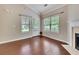 Cozy living room featuring hardwood floors, natural light, and a fireplace at 2384 Tree Arbor Way, Marietta, GA 30064