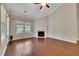 Open living room showcasing hardwood floors, fireplace and a trey ceiling with fan at 2384 Tree Arbor Way, Marietta, GA 30064