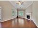 Well-lit living room features hardwood floors, a fireplace, vaulted ceiling, and modern ceiling fan at 2384 Tree Arbor Way, Marietta, GA 30064