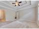 Bright main bedroom featuring a tray ceiling, ceiling fan, and a view into the main bathroom at 2384 Tree Arbor Way, Marietta, GA 30064