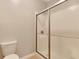 Shower with frosted glass and metal frame in a neutral-toned bathroom at 2384 Tree Arbor Way, Marietta, GA 30064