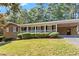 Inviting single-story brick home features a spacious front porch with decorative railings and an attached carport at 840 Hickory Sw Dr, Marietta, GA 30064