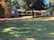 Charming single-story brick home with a long front porch, mature trees, and a large, well-maintained front yard at 840 Hickory Sw Dr, Marietta, GA 30064