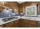 Well-lit kitchen features a gas cooktop, sleek backsplash, and ample cabinet space at 840 Hickory Sw Dr, Marietta, GA 30064