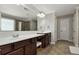 Bathroom features a large mirror, double sinks, and shower with tile surround at 2555 Blackstock Dr, Cumming, GA 30041