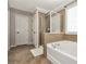 Bathroom features a tub and glass-enclosed shower with modern fixtures at 2555 Blackstock Dr, Cumming, GA 30041