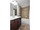 Bathroom featuring tile flooring, a shower, and wood cabinets at 2555 Blackstock Dr, Cumming, GA 30041