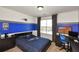 Bedroom with team-themed decor, work desk, and natural light at 2555 Blackstock Dr, Cumming, GA 30041