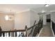 Upstairs hallway with overhead lighting and a view to downstairs living room at 2555 Blackstock Dr, Cumming, GA 30041