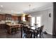 Eat-in kitchen with granite countertops, dark wood cabinets and floors, and stainless appliances at 2555 Blackstock Dr, Cumming, GA 30041