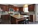 Modern kitchen features stainless appliances, gray backsplash, and dark wood cabinets and flooring at 2555 Blackstock Dr, Cumming, GA 30041