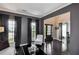 Spacious living room with dark hardwood floors, large windows, and an open view of the entryway at 2555 Blackstock Dr, Cumming, GA 30041