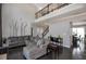 Open-concept living room featuring high ceilings, dark hardwood floors, and seamless access to dining and stairs at 2555 Blackstock Dr, Cumming, GA 30041