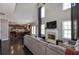Expansive living room with an open layout, hardwood floors, and a fireplace with a view to the kitchen at 2555 Blackstock Dr, Cumming, GA 30041