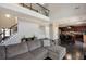 Open-concept living room features a large sectional, high ceilings, and view to the kitchen with stainless appliances at 2555 Blackstock Dr, Cumming, GA 30041