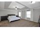 Spacious main bedroom features a tray ceiling, neutral paint, and large windows at 2555 Blackstock Dr, Cumming, GA 30041