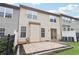 Rear view of a townhouse featuring a small stone patio and fenced yard at 3325 Castleberry Village Cir, Cumming, GA 30040