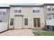 Townhouse rear elevation showing the small patio, double doors, and small fenced yard at 3325 Castleberry Village Cir, Cumming, GA 30040