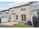 Rear exterior of townhouse with a small patio, fenced yard, and double French doors at 3325 Castleberry Village Cir, Cumming, GA 30040