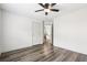 Bedroom featuring wood-look flooring, ceiling fan, and a view into the home hallway at 3325 Castleberry Village Cir, Cumming, GA 30040