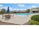 Community pool with seating and umbrellas with well maintained landscaping on a sunny day at 3325 Castleberry Village Cir, Cumming, GA 30040