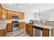 Kitchen with stainless steel appliances, wood cabinets, granite countertops, and hardwood floors at 3325 Castleberry Village Cir, Cumming, GA 30040