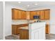Kitchen with wooden cabinets, granite countertops, stainless steel appliances, and hardwood floors at 3325 Castleberry Village Cir, Cumming, GA 30040