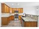 Modern kitchen featuring granite countertops, stainless steel appliances, and wooden cabinets at 3325 Castleberry Village Cir, Cumming, GA 30040