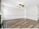 Living room with hardwood floors, bright walls, a ceiling fan, and natural light from surrounding windows at 3325 Castleberry Village Cir, Cumming, GA 30040
