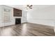 Spacious living room with a fireplace, hardwood floors, and plenty of bright light from surrounding windows at 3325 Castleberry Village Cir, Cumming, GA 30040