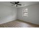 Bright bedroom with wood-look floors, a ceiling fan, and a window overlooking the neighborhood at 6322 Phillips Creek Dr, Lithonia, GA 30058