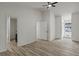 Spacious bedroom featuring a ceiling fan, two closets, and wood-look laminate flooring at 6322 Phillips Creek Dr, Lithonia, GA 30058